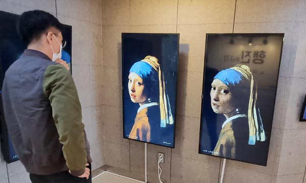 Visitor viewing artwork at the women’s rights exhibition